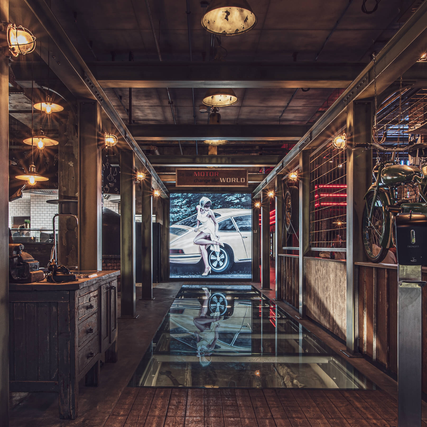 Retro garage with glass floor, car mural and bicycle on the side.